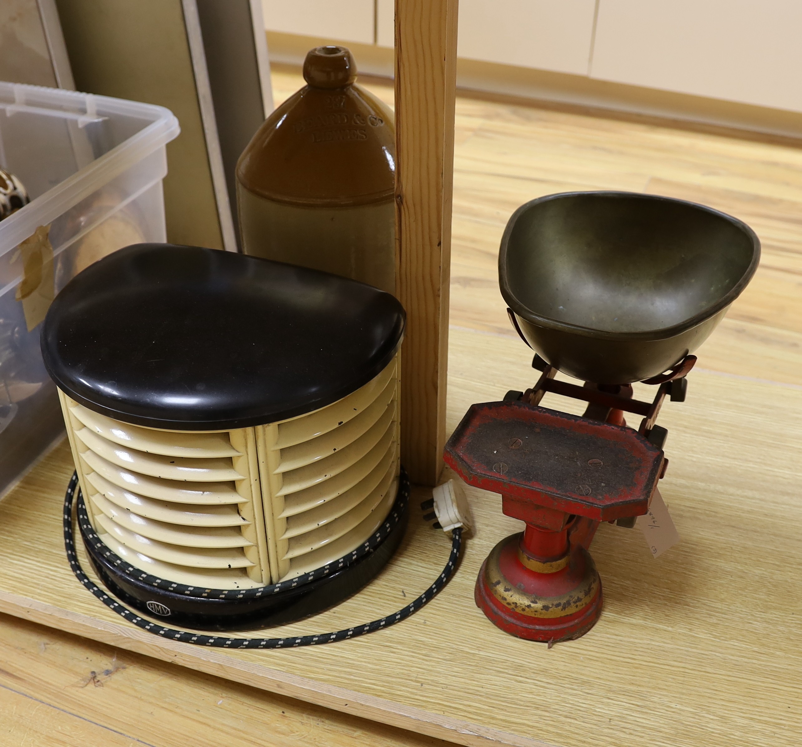 A 1930's HMV bakelite electric heater, A Mattocks cast iron weighing scale and a Lewes stoneware jar